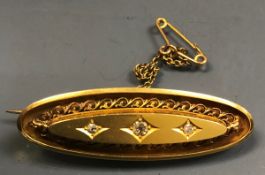 A Victorian gold bar brooch set with thr