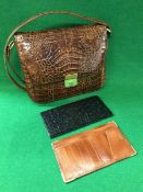 A crocodile skin crossover handbag stamp