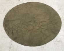 A modern circular rug of plain taupe col