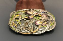 A white metal nurse's buckle with iris a