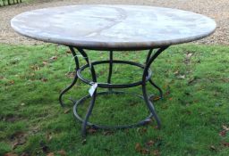 A wrought iron based marble top garden t