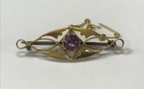 A Victorian 9 carat bar brooch set with
