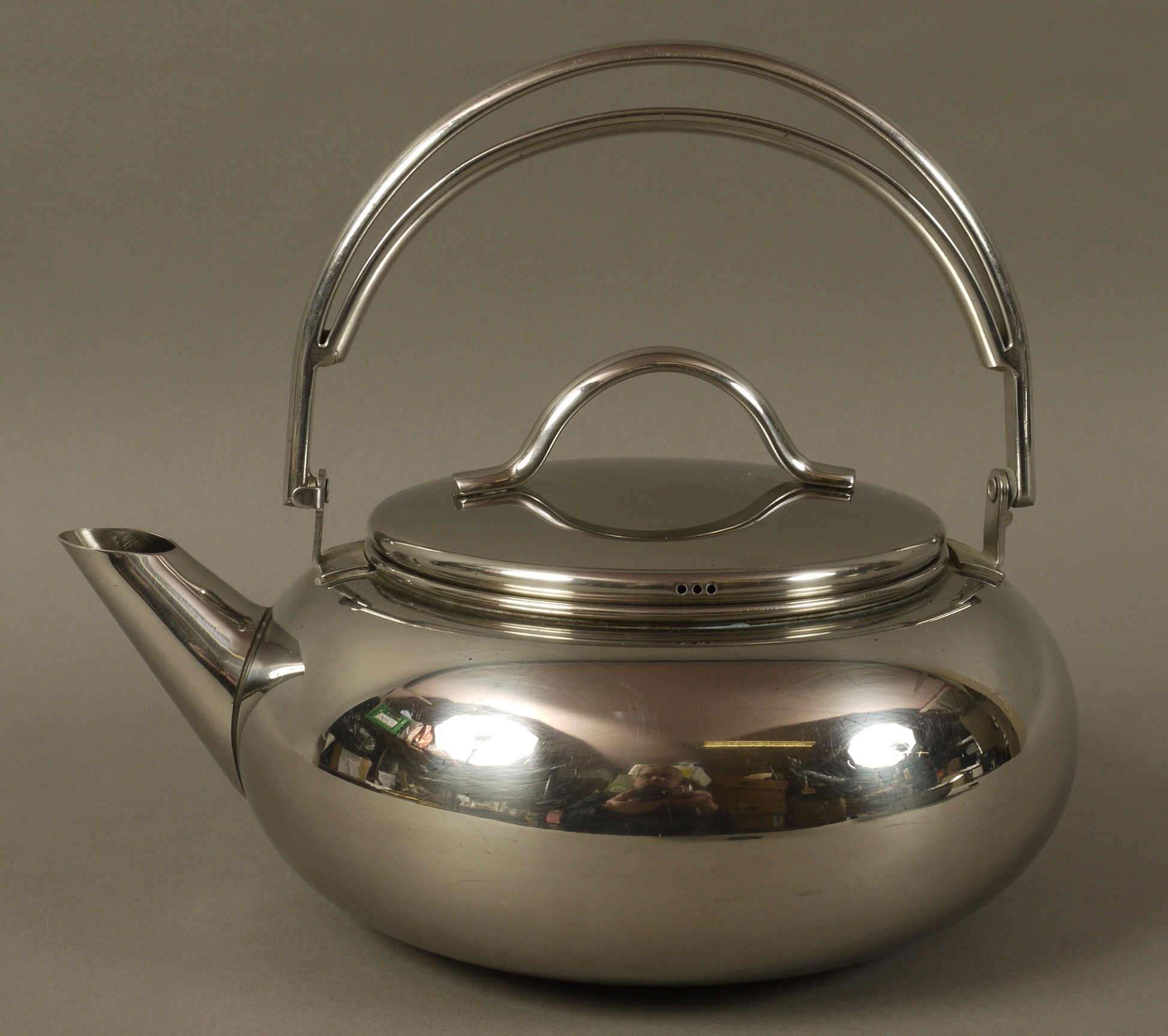 A stainless steel AGA kettle of compressed cauldron shape, slightly domed lid with strap handle,