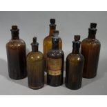 Six brown glass bottles moulded 'Poison' and ribbed, various sizes,