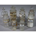 Ten late 19th/early 20th century clear glass pharmacy bottles, cylindrical,