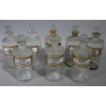 A set of eight late 19th/early 20th century clear glass pharmacy bottles, cylindrical,