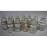 A set of eleven late 19th/early 20th century clear glass pharmacy bottles, cylindrical,