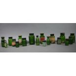A quantity of green glass pharmacy bottles with black or brown screw on lids, various sizes,