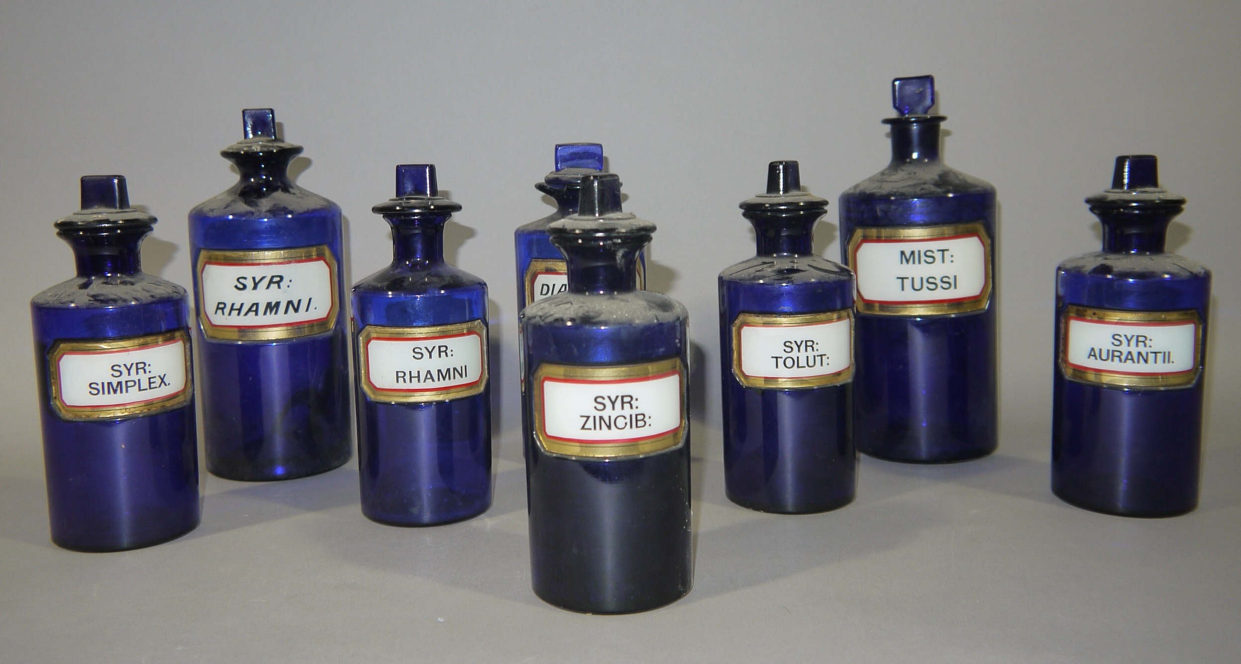 A set of five late 19th/early 20th century blue glass pharmacy bottles, cylindrical, - Image 2 of 2