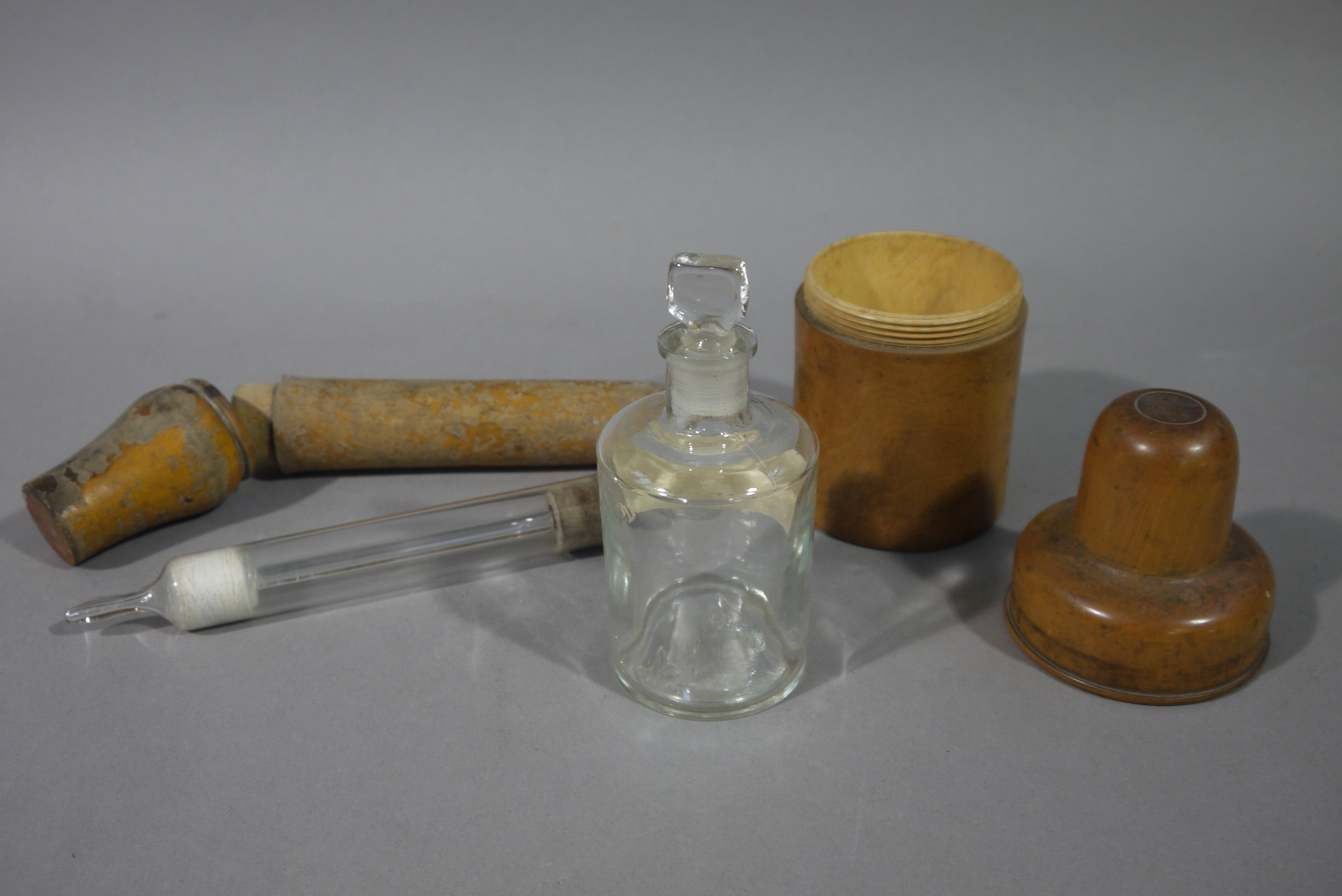 A Victorian treen bottle case for Allisons Chemist & Druggist of Cockermouth 14cm high together