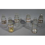 A set of six late 19th/early 20th century clear glass pharmacy bottles, cylindrical,