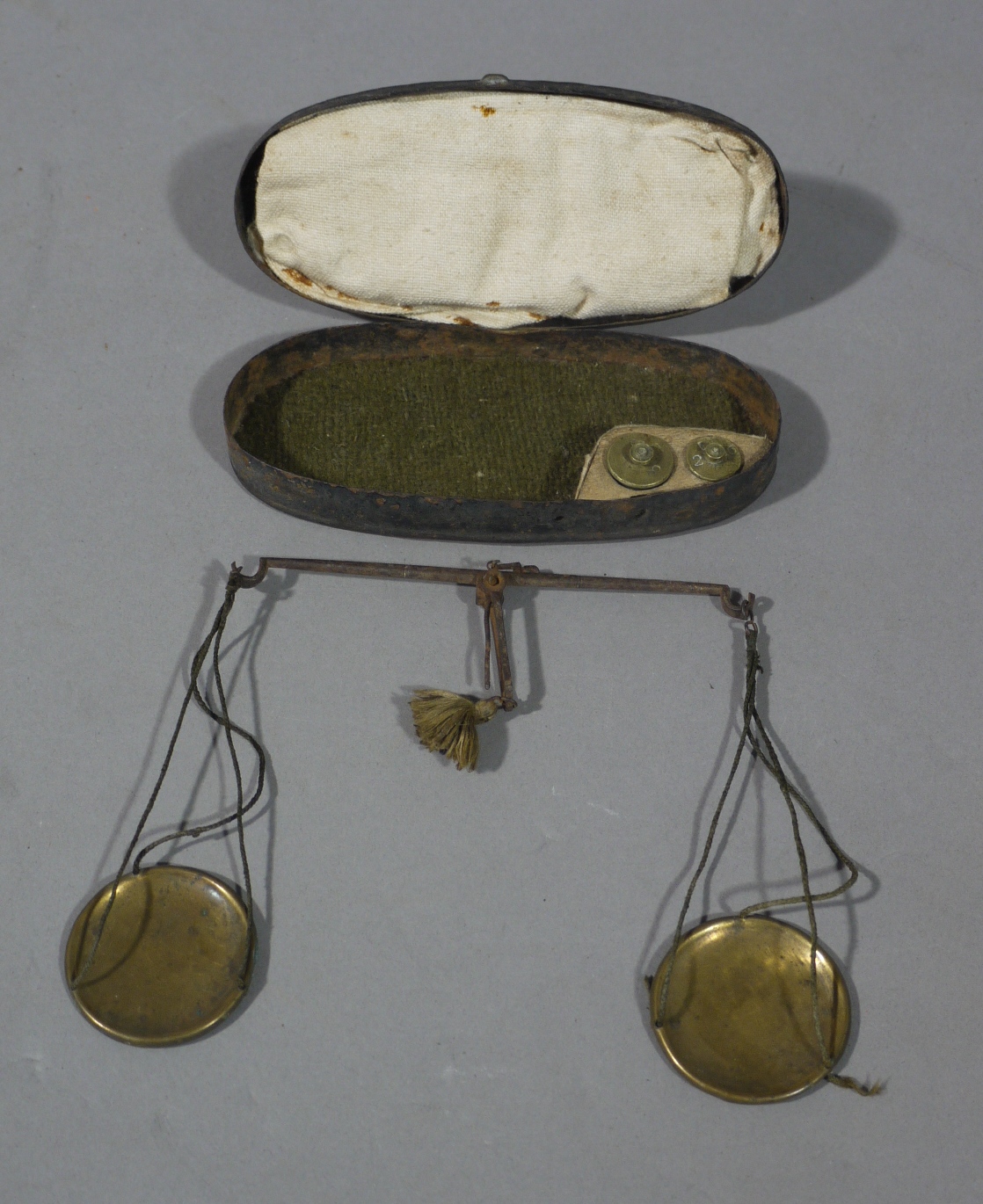 A set of 19th century apothecary's balance scales with two weights,