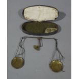 A set of 19th century apothecary's balance scales with two weights,