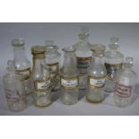 Nine late 19th/early 20th century clear glass pharmacy bottles, cylindrical,