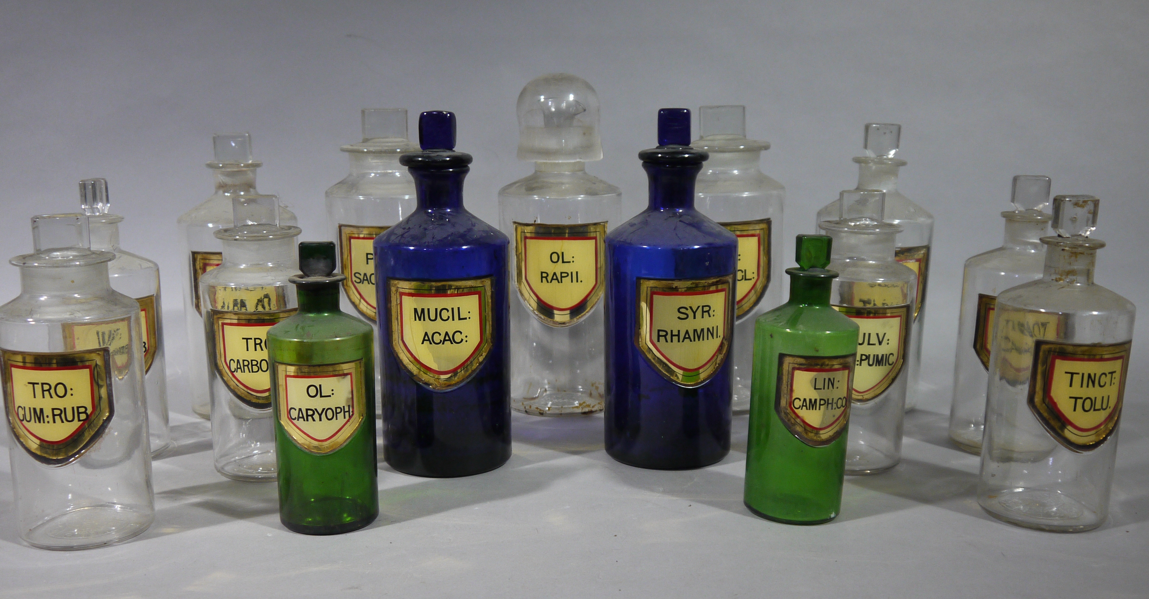 Fifteen late 19th century glass pharmacy bottles, cylindrical,