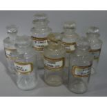 A set of seven late 19th/early 20th century clear glass pharmacy bottles, cylindrical,
