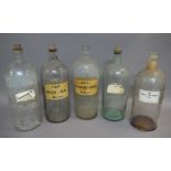 Five large pharmacy bottles, cylindrical, with cork stoppers, 33cm x 2,