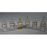 A near set of six late 19th/early 20th century clear glass pharmacy bottles, cylindrical,