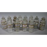 A near set of twelve late 19th/early 20th century clear glass pharmacy bottles, cylindrical,