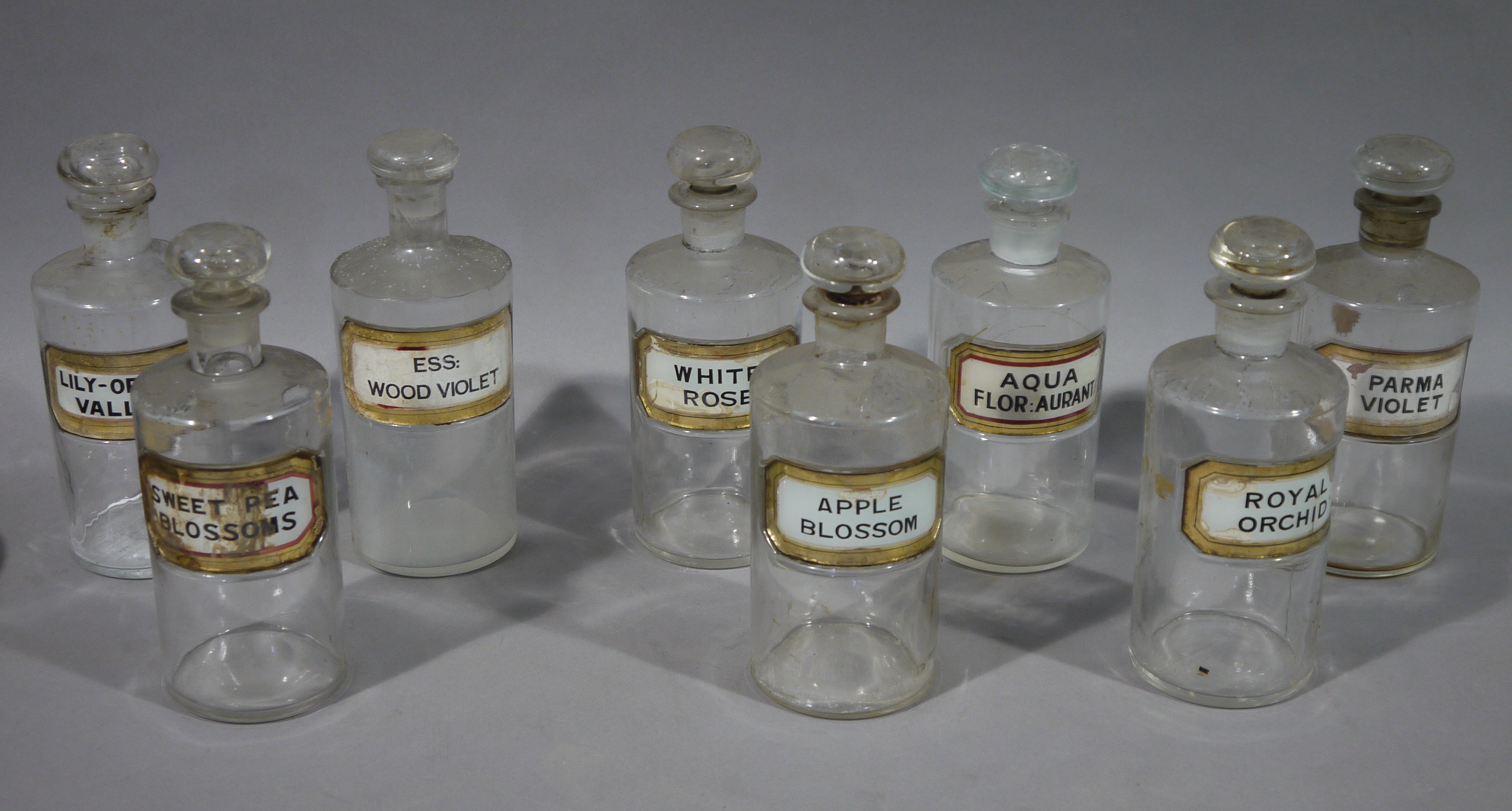 A set of six late 19th/early 20th century pharmacy bottles for toilet water, cylindrical,