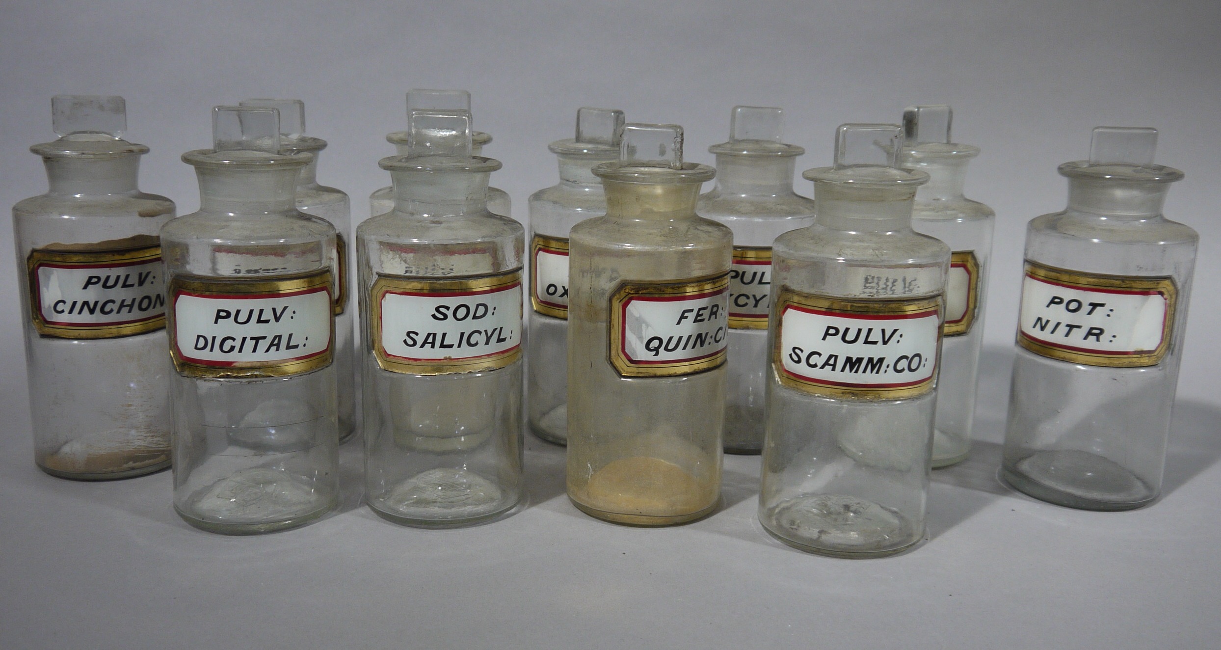 A set of eleven late 19th/early 20th century clear glass pharmacy bottles, cylindrical, - Image 3 of 3