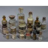 A quantity of medicine bottles with cork and treen stoppers of various sizes 6.5cm to 4.