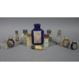 A collection of small pharmacy bottles including a blue glass triangular poison bottle,