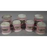 A set of seven 19th century pink and white pottery cylindrical drug jars,