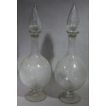 A pair of Victorian apothecary's glass display bottles with faceted hollow spire stopper,