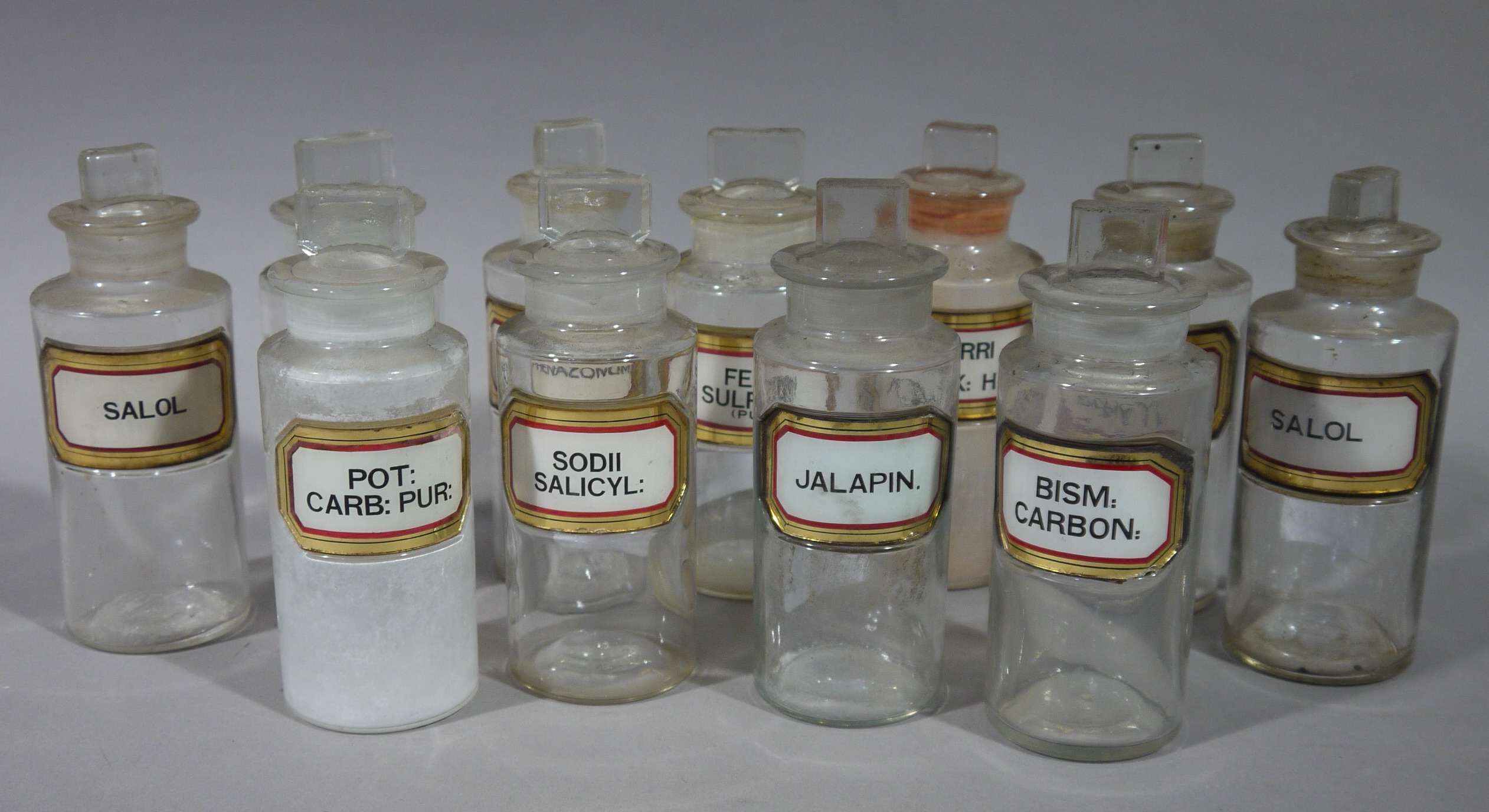 A set of eleven late 19th/early 20th century clear glass pharmacy bottles, cylindrical, - Image 2 of 3