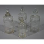 A 19th century pair and two similar clear glass pharmacy bottles, cylindrical,