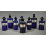 A set of five late 19th/early 20th century blue glass pharmacy bottles, cylindrical,