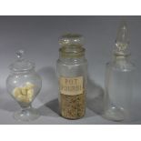 Three early to mid 20th century apothecary's glass display jars, cylindrical and baluster shapes,