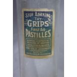 A glass cylindrical 'Grips Pastilles' jar with triple stepped cover and foot,