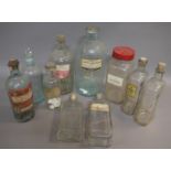 Ten clear glass pharmacy bottles, including the moulded 'Poison', a blue tinted bottle,