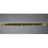 A glass reverse printed sign 'Dispensing Department',
