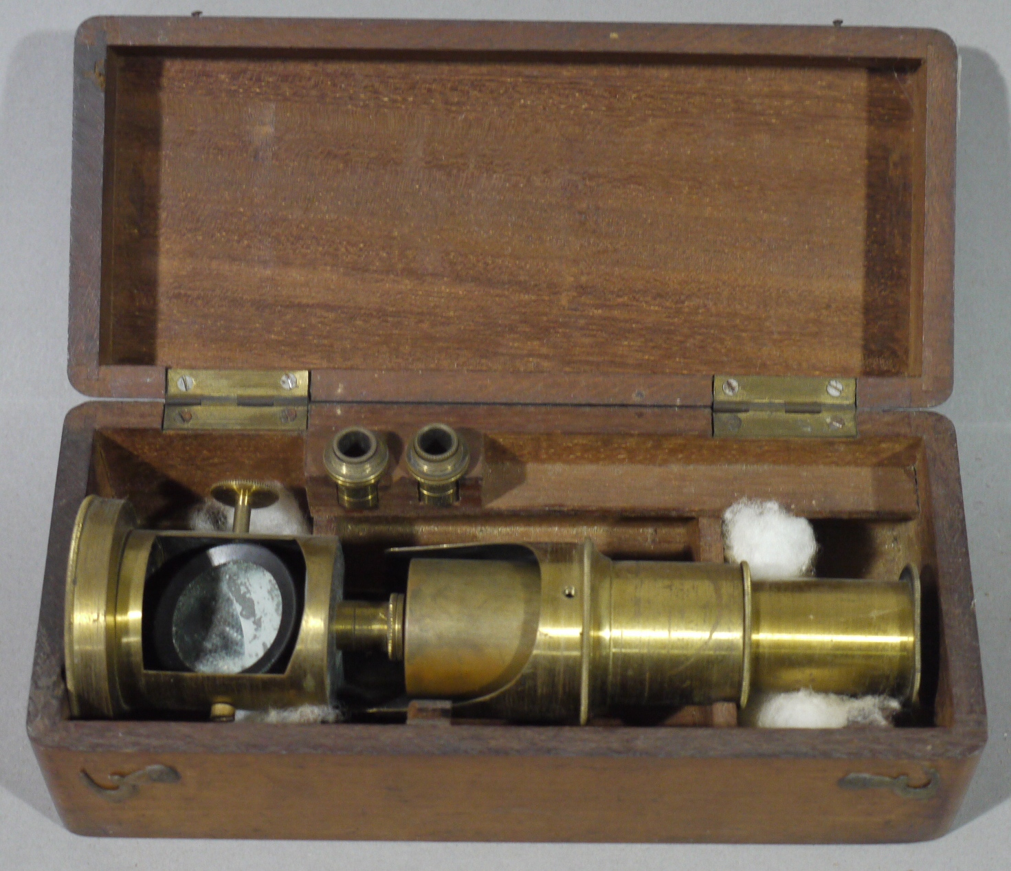 A Victorian brass monocular in mahogany fitted case