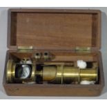 A Victorian brass monocular in mahogany fitted case