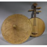 A musical instrument with cylindrical drum shaped flattened belly, fluted pegs,