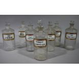 A set of eight late 19th/early 20th century clear glass pharmacy bottles, cylindrical,