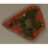 A cold painted bronze walnut inkwell seated on a realistic leaf and red marble base,