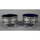 A pair of Victorian open salts of oval outline with blue glass liners,