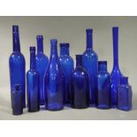 A quantity of blue glass bottles