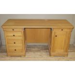 A reproduction twin pedestal desk , the rounded rectangular top above kneehole recess,