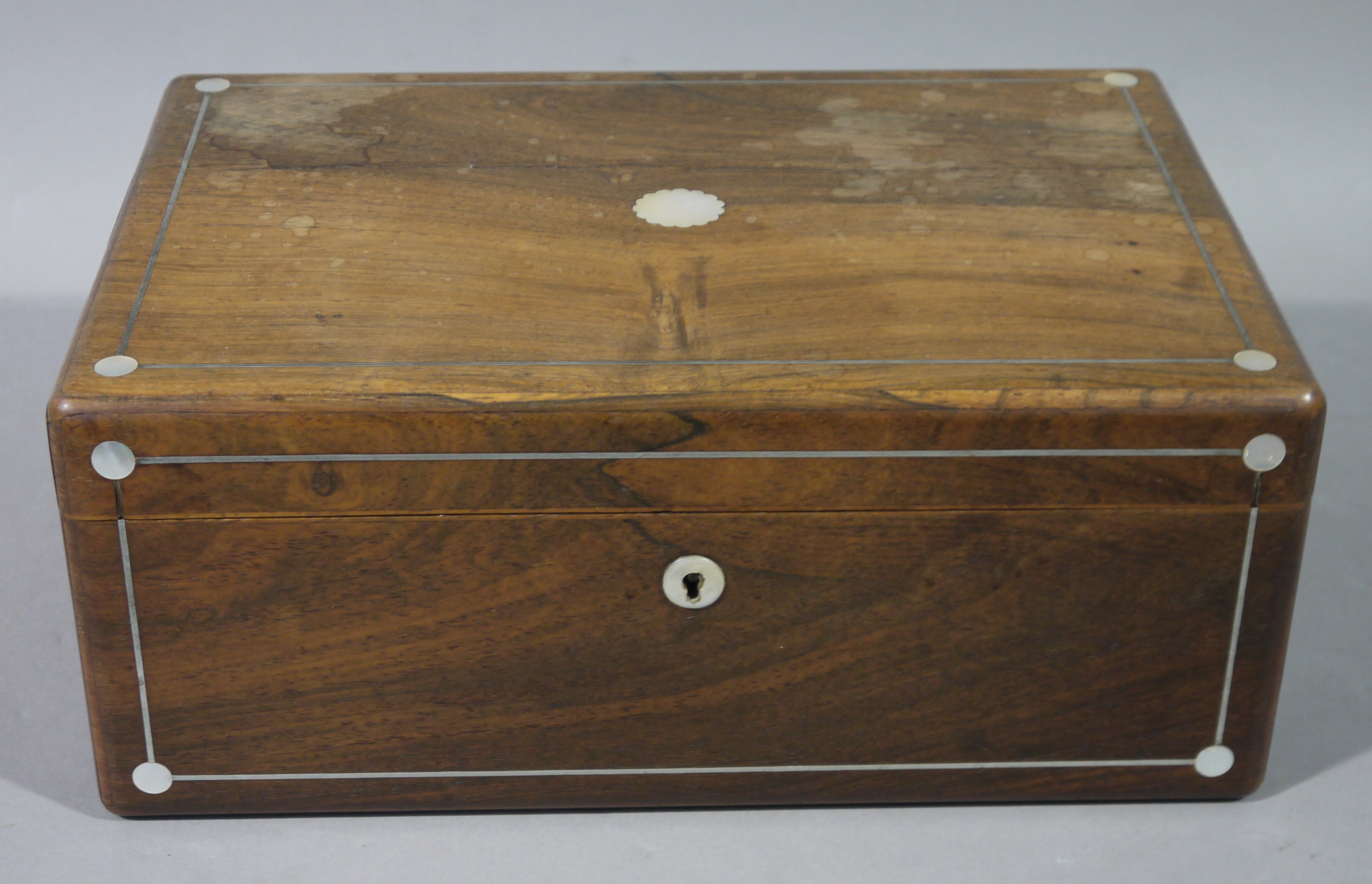 A Victorian rosewood veneered box inlaid with mother of pearl circlets to the corners and string