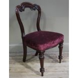A Victorian mahogany single chair having a triple arched back with C-scroll moulding,
