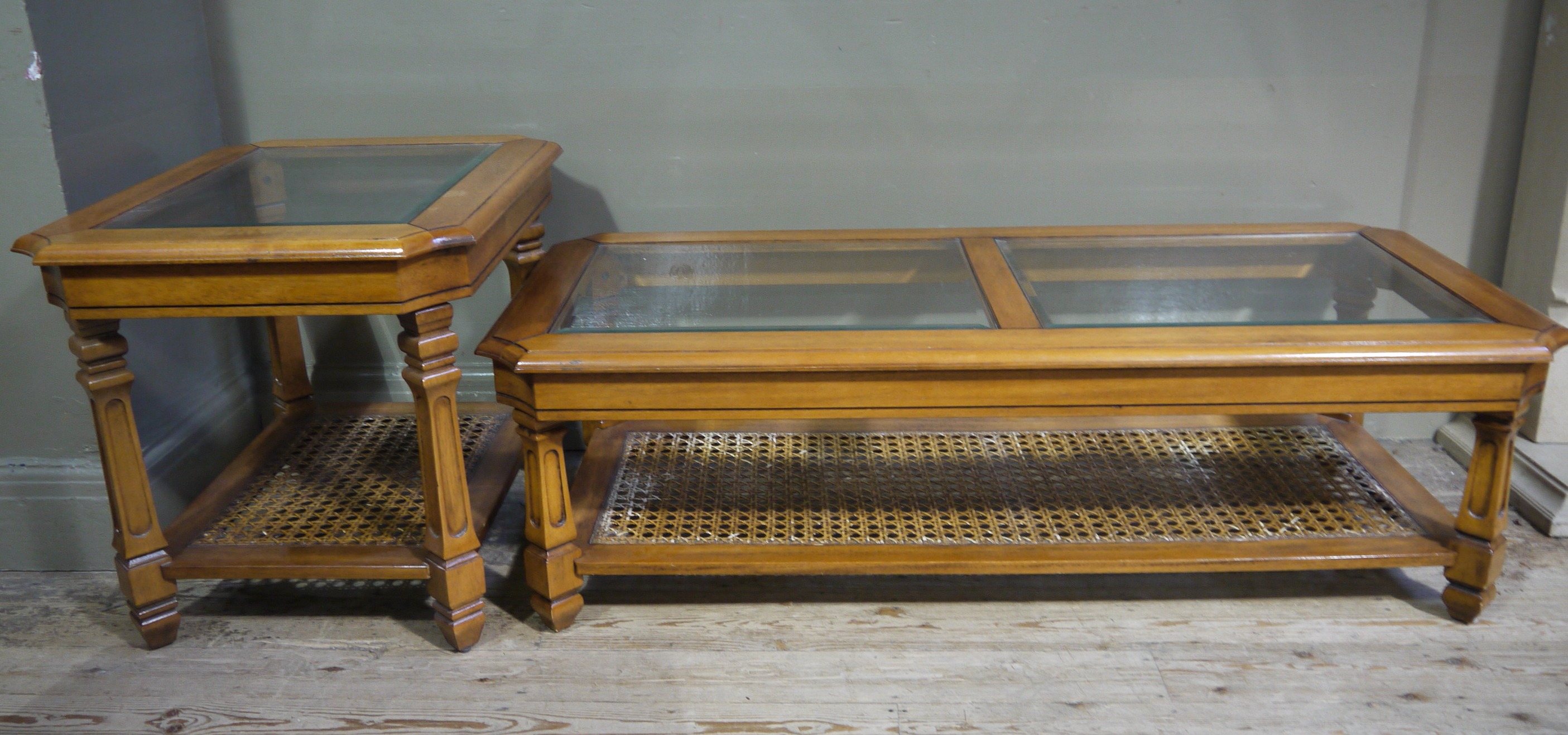 A cherrywood and glass top coffee table with bergere caned undertier and matching lamp table