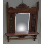 A reproduction mahogany wall mirror with shelf and rail