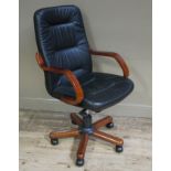 An office chair with mahogany stained wooden frame,