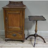 A late 19th century walnut cabinet having a raised back carved in relief with ribbons with a above